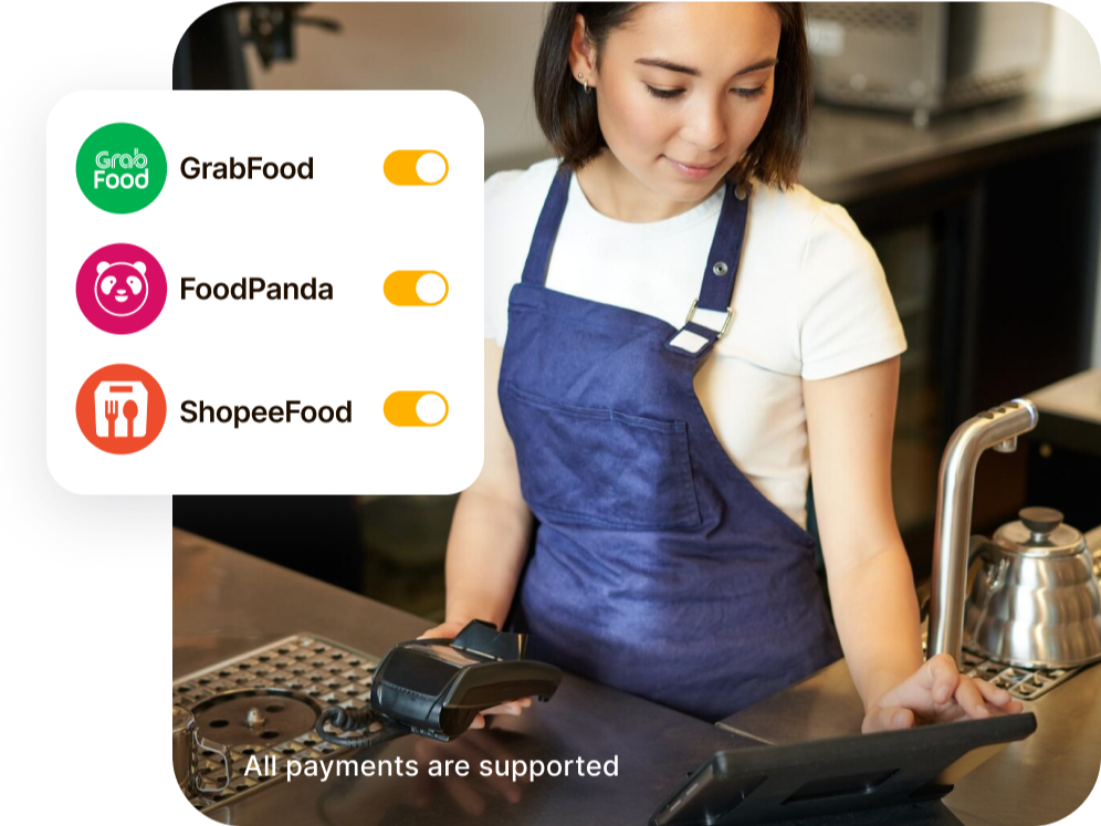 Restaurant owner in blue apron manages orders and business operations on a tablet with Hubbo POS integration.